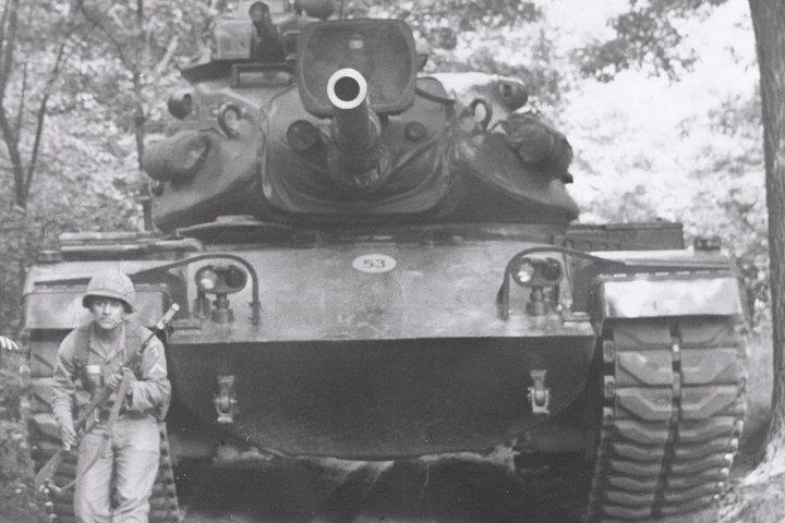 Pedro Vasquez Loredo Jr. in uniform, standing next to a tank during his Vietnam service